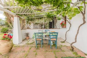 a patio with a table and chairs under a pergola at Rai's Room 1 - Nature and Panoramic View in Stazione Olbia