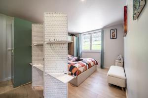 a bedroom with a bed and a book shelf at Alpine ski apartment - Petit Chatel in Châtel