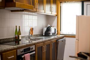 a kitchen with a sink and a stove top oven at Quinta da Caselinha in Paredes de Coura