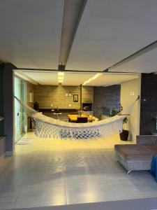 a living room with a hammock in the middle of a room at Apartamento amplo João VI in Muriaé +14 photos