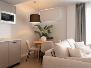 a living room with a couch and a table at Meral Units in Fuengirola