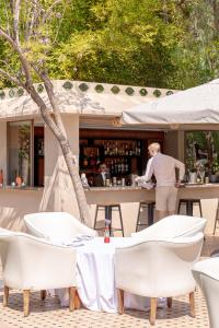 a woman is standing at a bar in front at PL Place Boutique Hôtel & Restaurant in Marrakesh