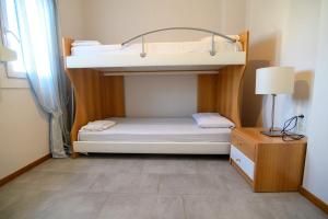 a small bedroom with a bunk bed and a table at Spacious 2 Bd Balcony Apt in Preveza in Preveza