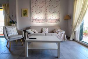 a living room with a couch and a table at Spacious 2 Bd Balcony Apt in Preveza in Preveza +31 photos