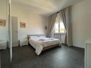 a bedroom with a bed and a large window at Residence Greta in Parma +27 photos