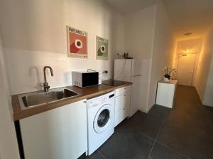 a kitchen with a sink and a washing machine at Residence Greta in Parma