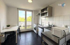 a kitchen with a sink and a counter with a window at BEGE APARTMENTS HomeAway in Marl