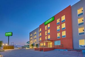 a hotel with a sign on the side of it at City Express Junior by Marriott Guadalajara Periferico Sur in Guadalajara
