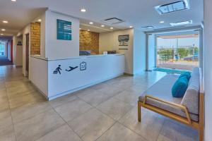a lobby of a hospital with a reception desk at City Express Junior by Marriott Guadalajara Periferico Sur in Guadalajara
