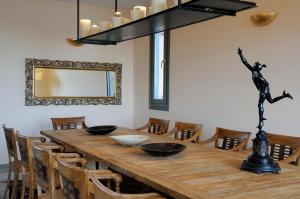 a dining room with a wooden table and chairs at Aegea Blue Cycladic Resort in Zorgos 