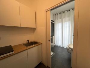 a bathroom with a sink and a toilet at Residence Greta in Parma
