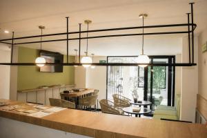a kitchen and dining room with a large chandelier at Casa Siete Hotel Boutique in Bogotá