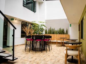 a room with stools and tables in a building at Casa Siete Hotel Boutique in Bogotá