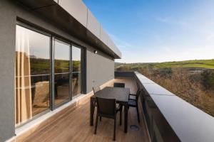 a dining table on the balcony of a house at Hilas Thermal Resort Spa & Aquapark in Ladik