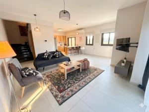 a living room with a couch and a table at Niko's Modern Family Home near the Beach in Limassol
