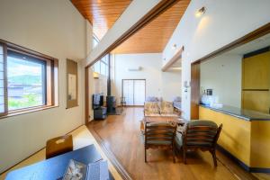 a living room with a table and chairs at Good MorningHouse in Takayama