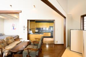 a living room with a couch and a table at Good MorningHouse in Takayama