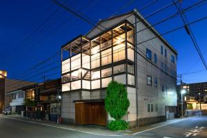 a building on a city street at night at Good MorningHouse in Takayama