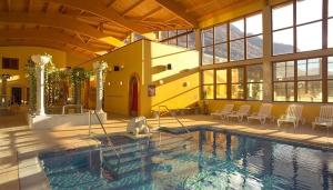 a large swimming pool in a large building at Chez Mina in Saint-Béat