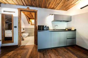 a kitchen with a sink and a mirror in a room at Chalet Les Airelles in Valtournenche +76 photos