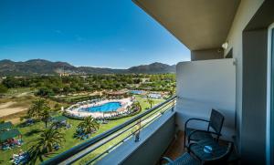 a balcony with a view of a resort at Hotel Spa Mediterráneo Park in Roses