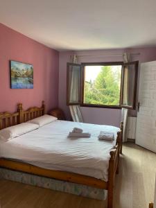 a bedroom with a large bed with a window at Apartamento en Formigal in Formigal