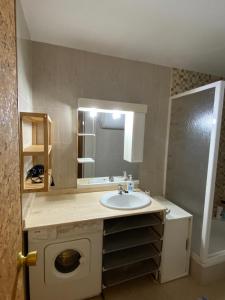 a bathroom with a sink and a mirror at Apartamento en Formigal in Formigal