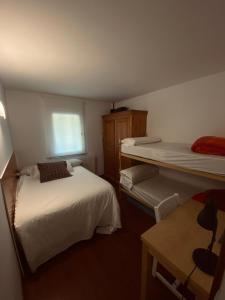 a small bedroom with two beds and a window at Apartamento en Formigal in Formigal