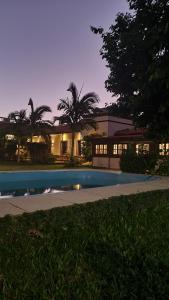 a house with a swimming pool in front of a building at Nido de Pajaros Posada Boutique in Concepción