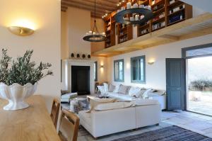 a living room with a white couch and a table at Aegea Blue Cycladic Resort in Zorgos 