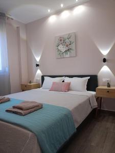 a bedroom with two beds with towels on them at Celestia Irene Suites 2 in Vromerí