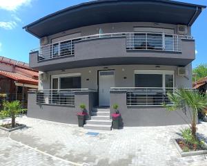 a large house with stairs and plants in front of it at Celestia Irene Suites 2 in Vromerí