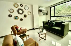 a living room with a couch and chairs and a window at Lovely 2BD City Condo with parking in Guayaquil