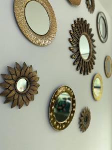 a group of mirrors hanging on a wall at Lovely 2BD City Condo with parking in Guayaquil