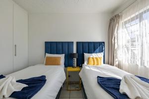 two beds sitting next to each other in a bedroom at Safi Self-catering Suite 2 in Bunkers Hill