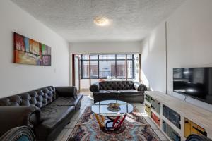 a living room with couches and a coffee table at Safi Self-catering Suite 2 in Bunkers Hill