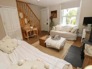 a living room with a bed and a couch at Fern Cottage in Bembridge