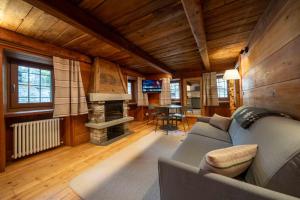 a living room with a couch and a fireplace at Chalet Les Airelles in Valtournenche