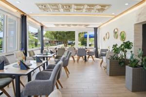 a restaurant with tables and chairs and windows at Schwarzwald Ledi - Bed & Breakfast Feldberg in Feldberg