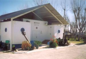a building with a us used unit with flowers in front at Caravana Camping Coelius in Miramar +5 photos