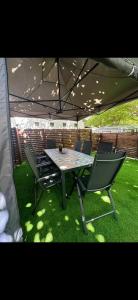 a table and chairs sitting under a tent at Caravana Camping Coelius in Miramar