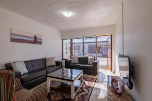 a living room with a couch and a table at Safi Self-Catering Suite 1 in Bunkers Hill