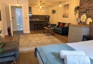 a bedroom with a bed and a living room at Large central studio Sleep 3 in Brighton & Hove