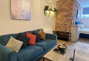 a living room with a blue couch and a table at Large central studio Sleep 3 in Brighton & Hove