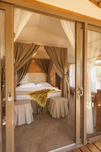 a bedroom with a bed in a tent at Le Lenze Don Mimì Glamping in Mattinata