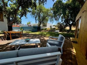 a patio with a couch and a table and some trees at Encanto de Azeitão in Aldeia de Irmãos