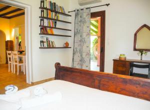 a bedroom with a bed and a mirror and a table at Lea's Ηοme in Kourouta