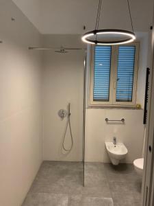 a bathroom with a shower and a toilet and a sink at Dazio Exclusive Rooms in Rome +26 photos