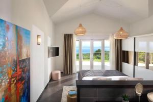 a bedroom with a bed and a large window at Luxury Panorama Vila with amazing Seaview in Gondolici 7 km from Rabac in Labin