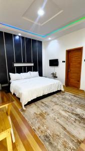 a bedroom with a large white bed and a rug at IFY LUXURY APARTMENTs in Maitama +5 photos